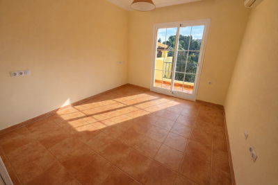 Sunlit-bedroom-with-balcony-view